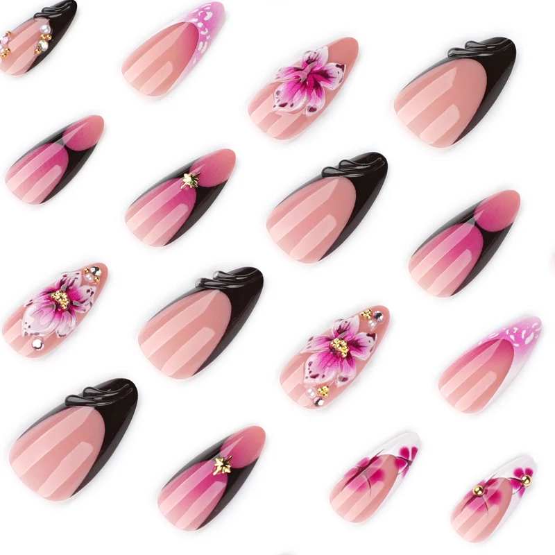 Kunstvolle Stiletto-Nägel mit blühendem Design und Glitzerakzenten Karnz