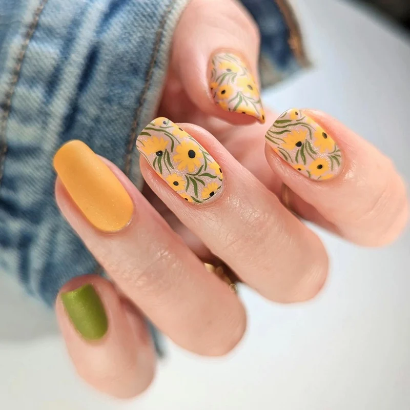 Artistic nail extensions with floral designs and creative color accents Stornfield