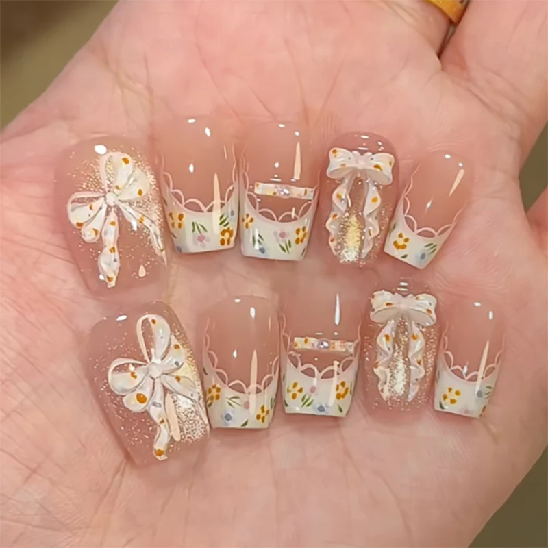 Artful Nail Extensions with Floral Design and Bow Accents Stornfield