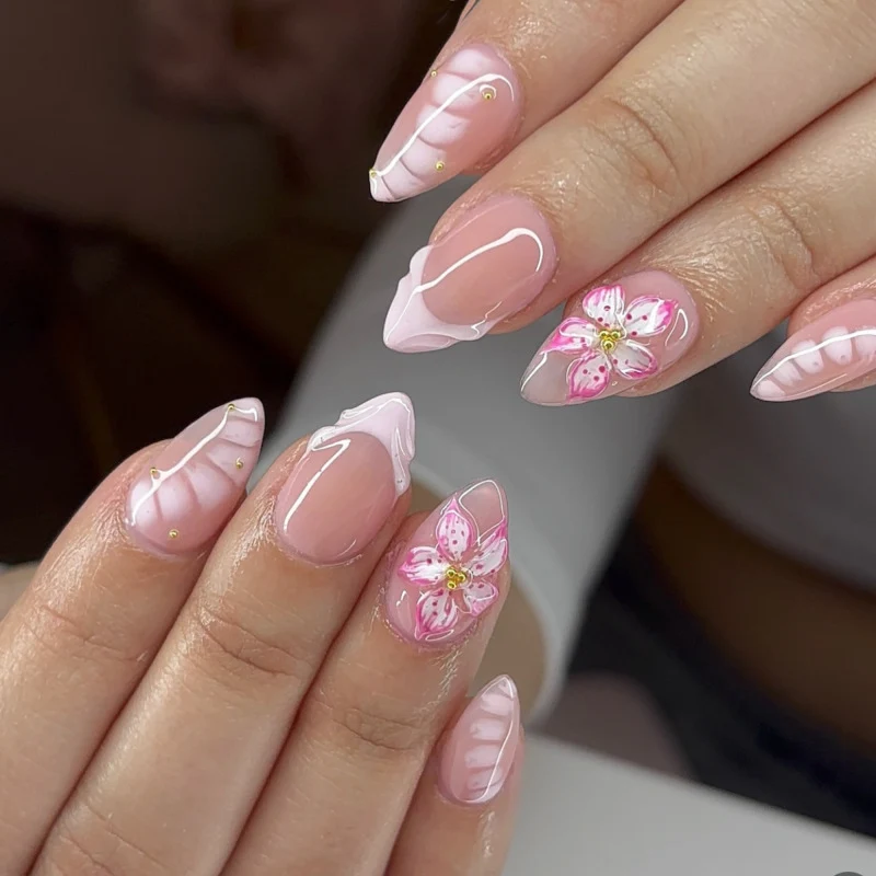Artful Nail Extensions with Floral Design and Glitter Accents Stornfield