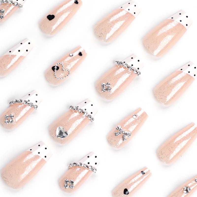 Artful nail extensions with elegant rhinestone and heart designs Stornfield