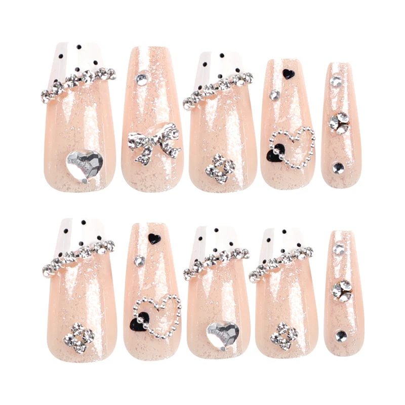 Artful nail extensions with elegant rhinestone and heart designs Stornfield