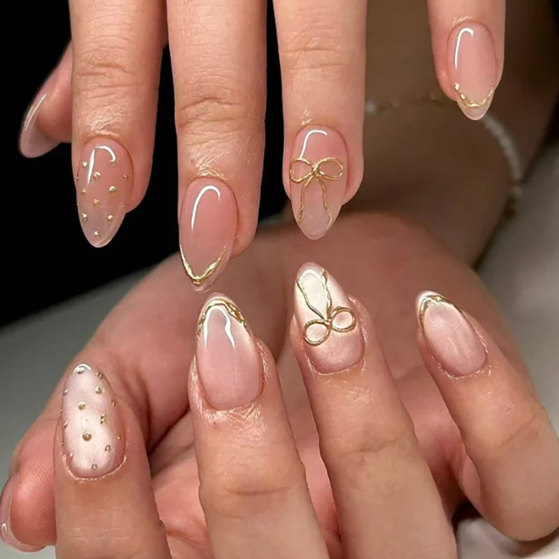 Artful nail extensions with elegant golden accents Stornfield