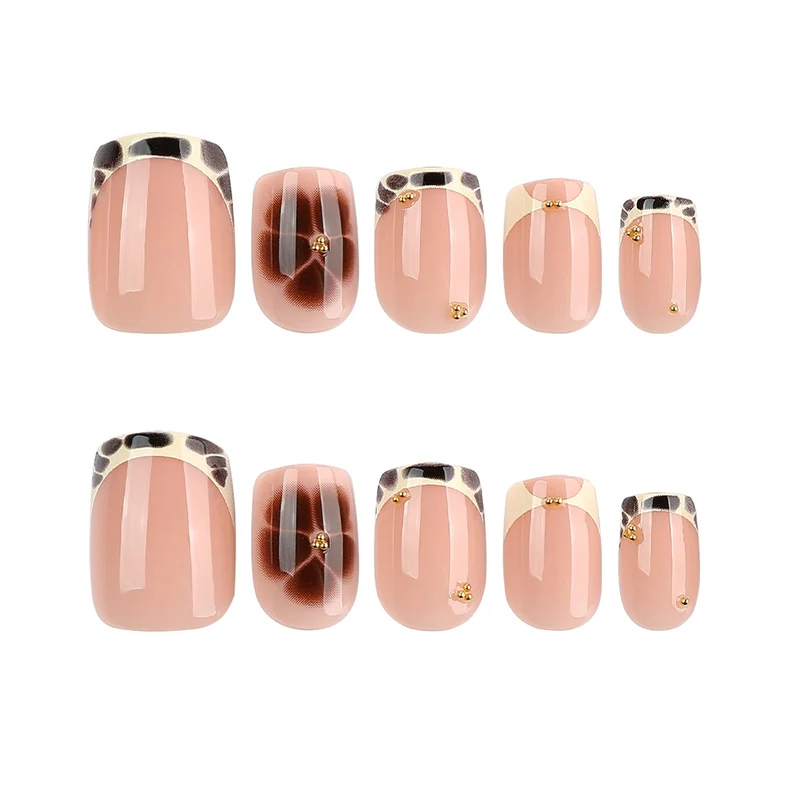 Artful nail extensions with an elegant giraffe pattern and golden accents Stornfield