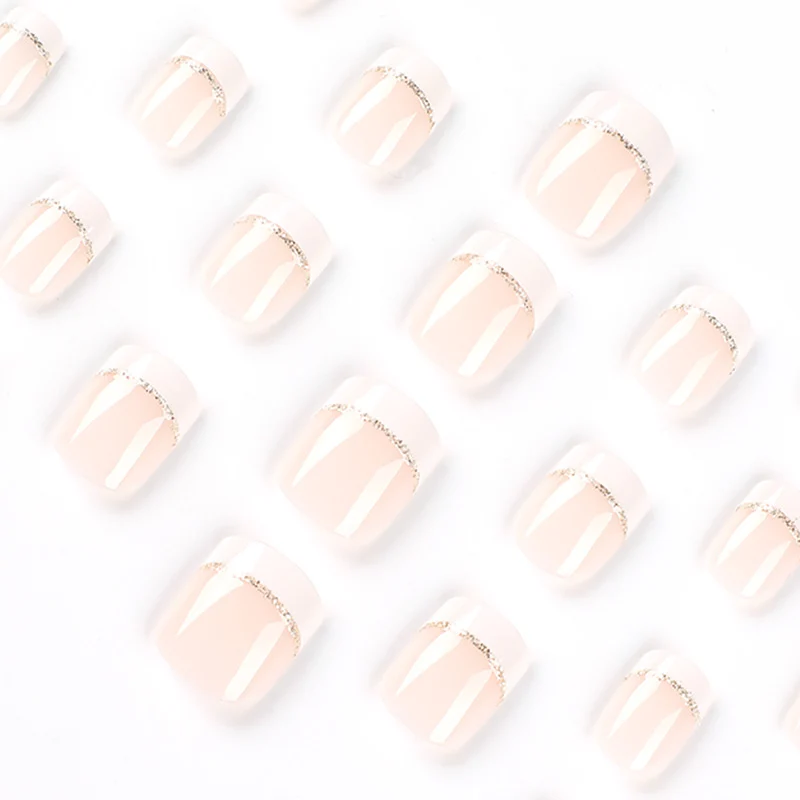 Artful nail extensions with elegant French tip and gold accents Stornfield