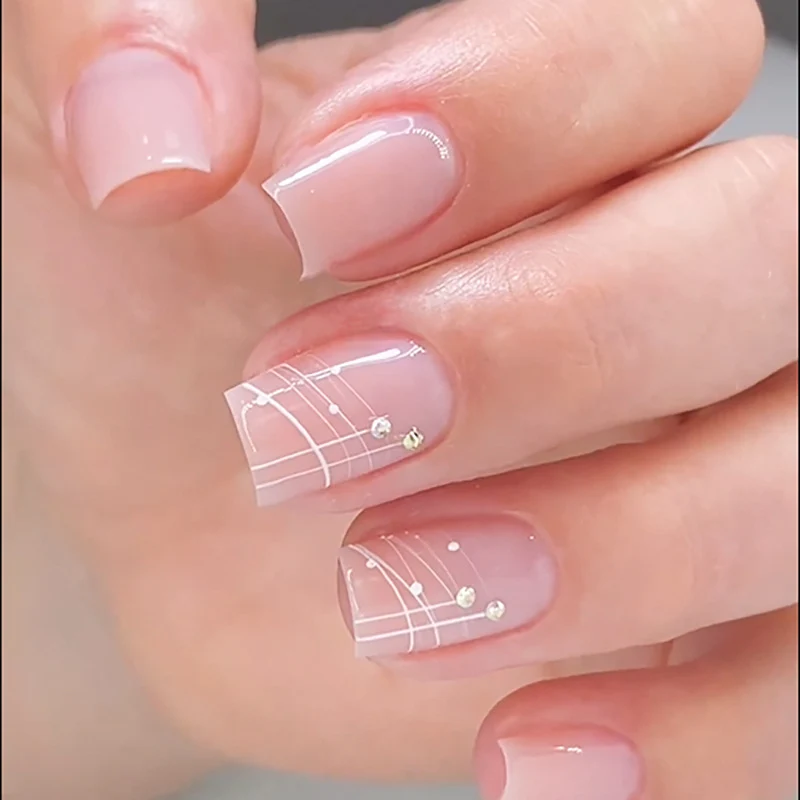 Artful nail extensions with elegant design and rhinestone embellishments Stornfield