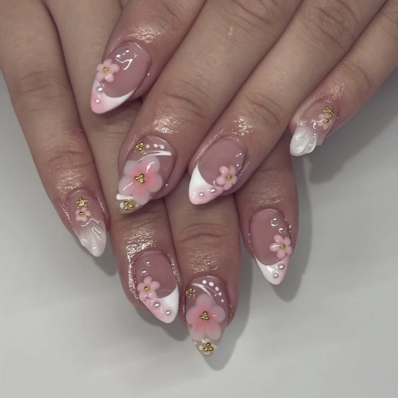Artful nail extensions with floral patterns and glitter accents Stornfield