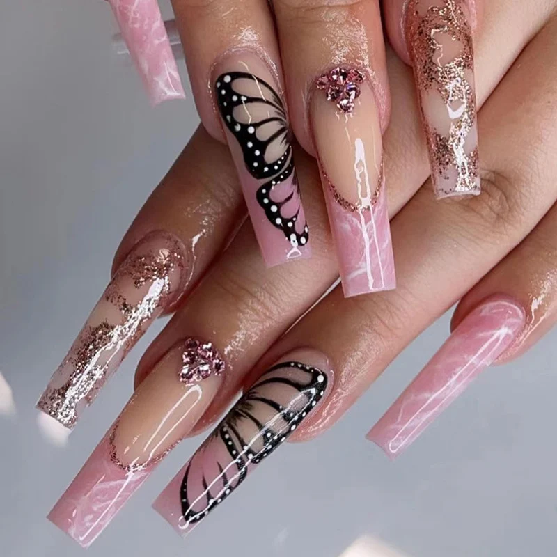 Glamorous nail extensions with beautiful butterfly motifs and glitter accents Stornfield