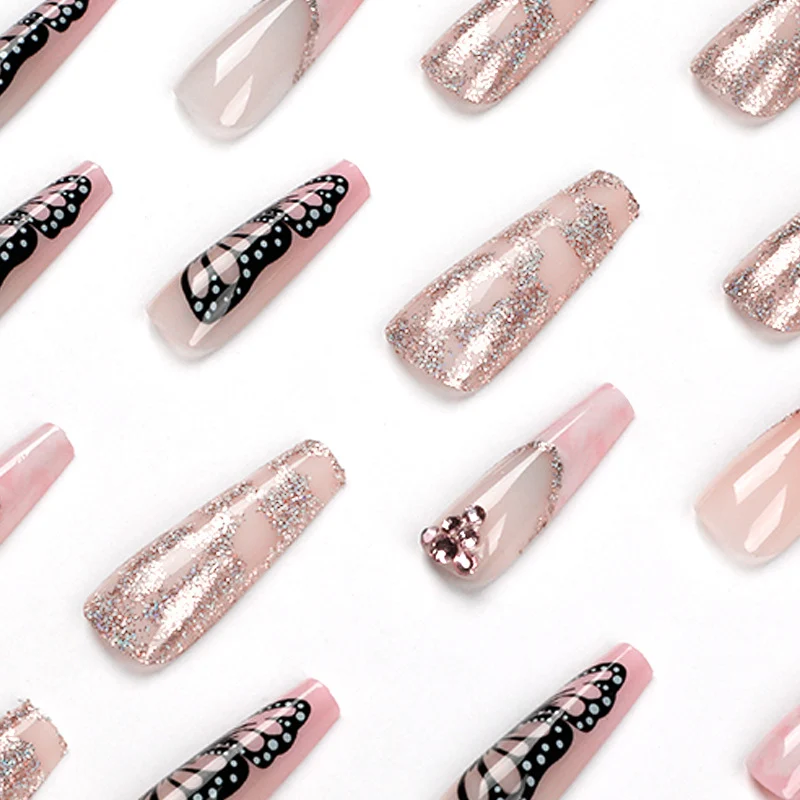 Glamorous nail extensions with beautiful butterfly motifs and glitter accents Stornfield