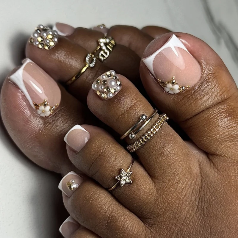 Glamorous toenail art with luxurious rhinestone and floral designs Stornfield