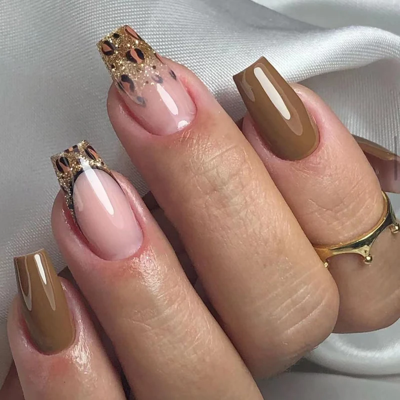Glamorous acrylic nails with glitter and leopard designs Stornfield