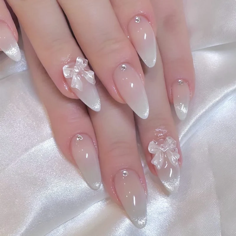 Elegant Stiletto Nails with Glitter and Bow Accents Stornfield
