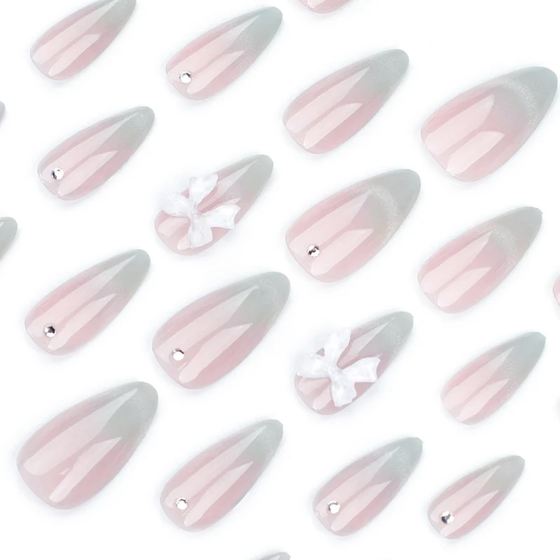 Elegant Stiletto Nails with Glitter and Bow Accents Stornfield