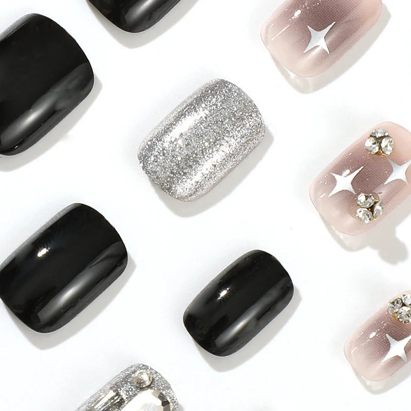 Elegant Nail Art with Glitter and Star Motifs Stornfield