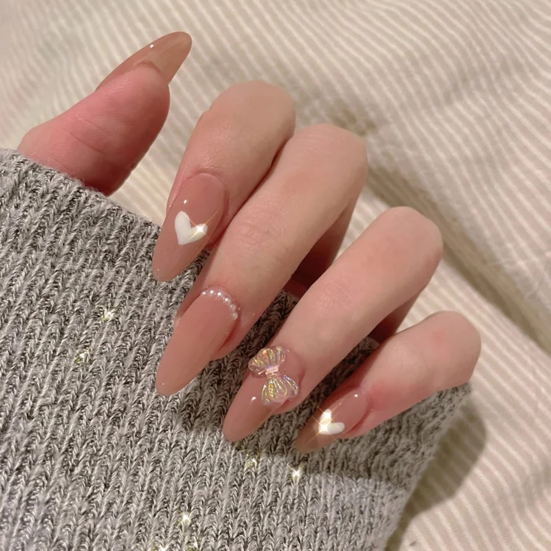 Elegant artificial nails with heart-shaped and glitter accents Stornfield