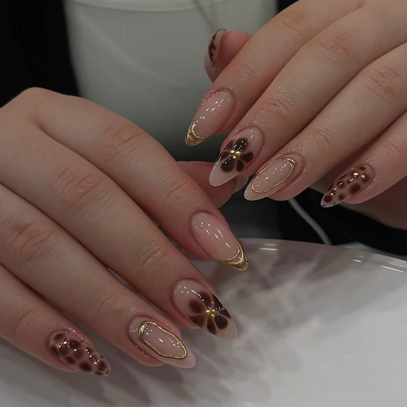 Elegant artificial nails with floral accents and gold details Stornfield