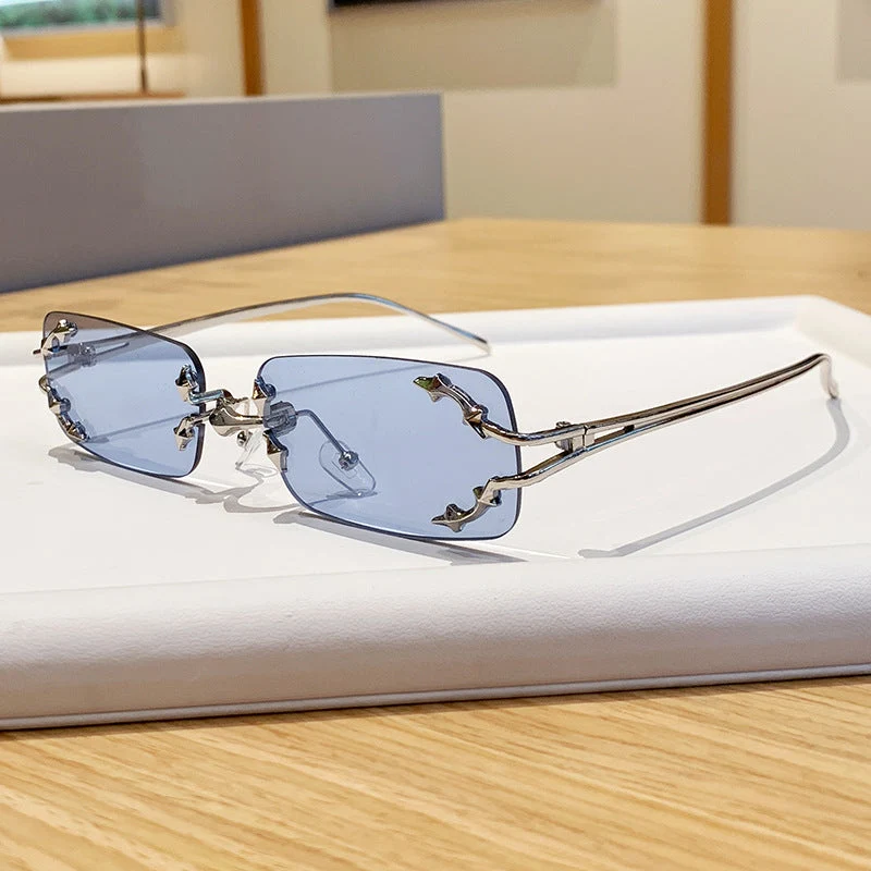 Dame moteriserte solbriller med filigran metallramme og transparente glass Luvikno