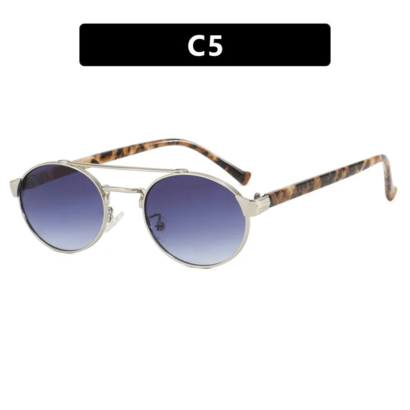 Dame moteriktig solbrille i stilfullt rundt design med gull aksenter Luvikno