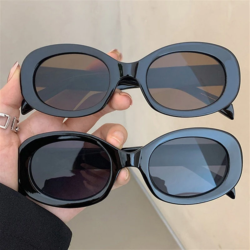 Dame moteriktig solbrille i elegant ovalt design med robust ramme Luvikno