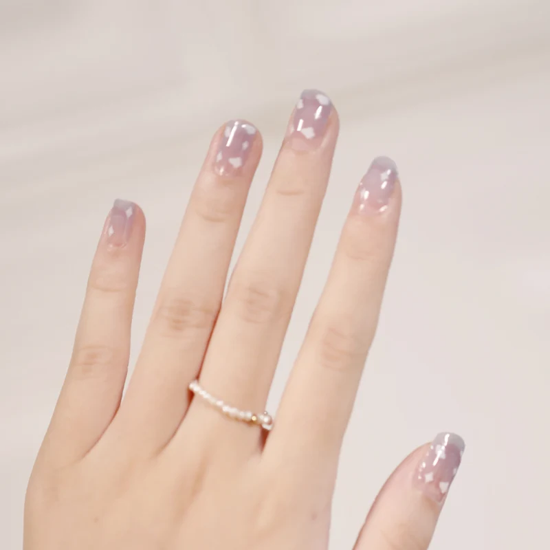Artificial nail art with heart-shaped designs and soft color gradients Stornfield