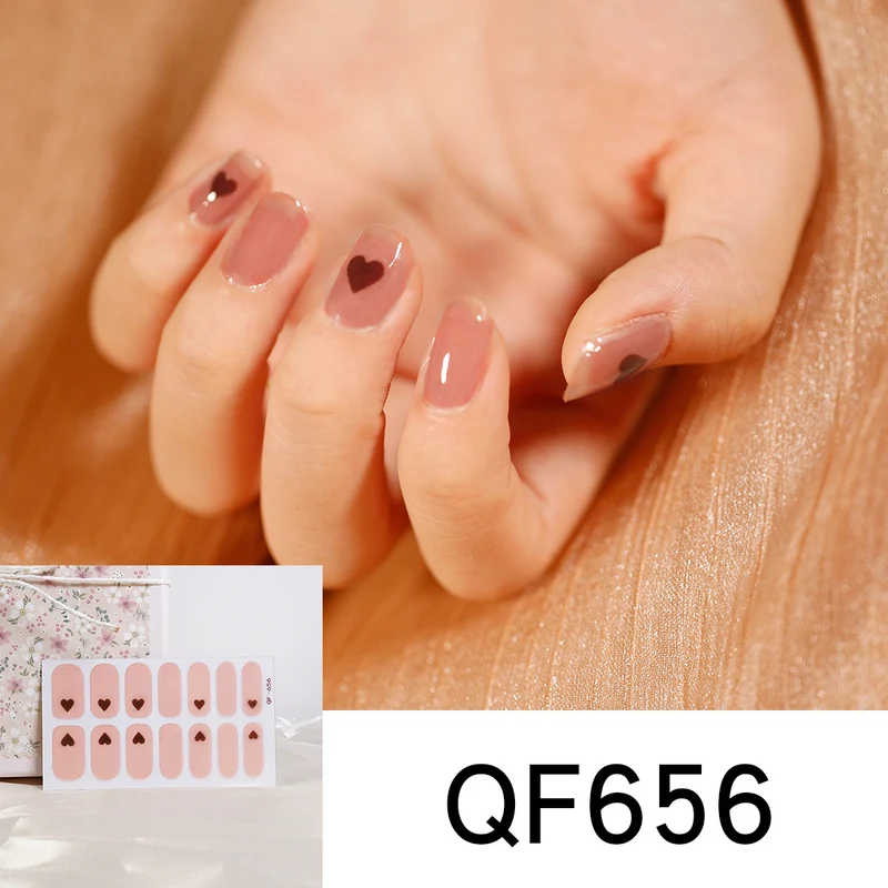 Artificial nail art with heart-shaped designs and soft color gradients Stornfield
