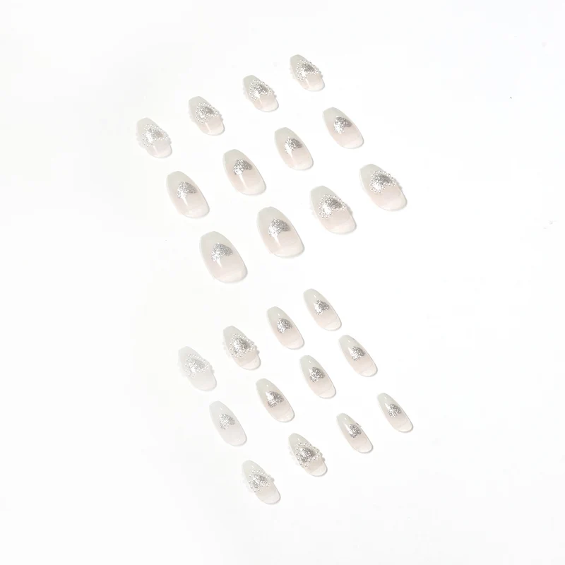 Artificial nail art with heart and rhinestone decorations Stornfield
