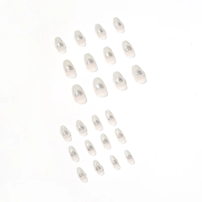 Artificial nail art with heart and rhinestone decorations Stornfield