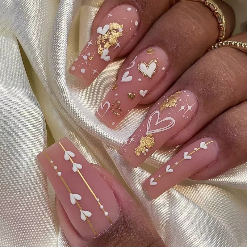 Artificial nail art with heart and glitter designs Stornfield