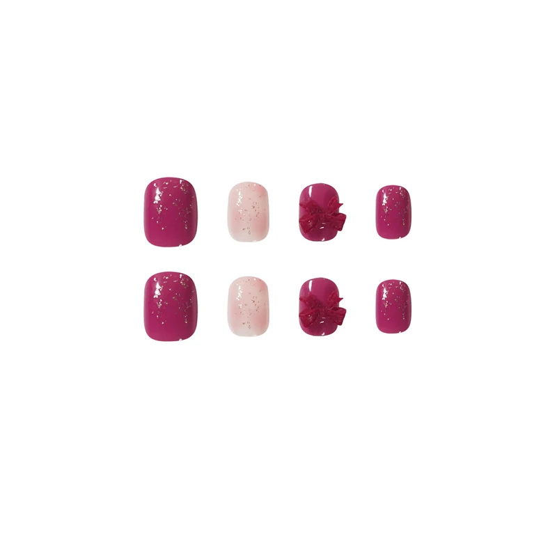 Artificial nail art with glitter embellishments and cute bow motif Stornfield