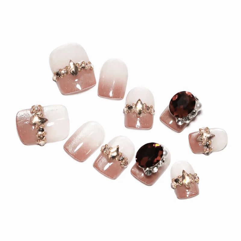 Artificial nail art with glitter and jewelry embellishments Stornfield