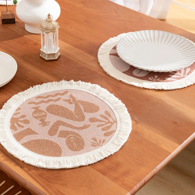 Rundes gewebtes Tischset mit Fransen und abstraktem Figurmotiv Karnz
