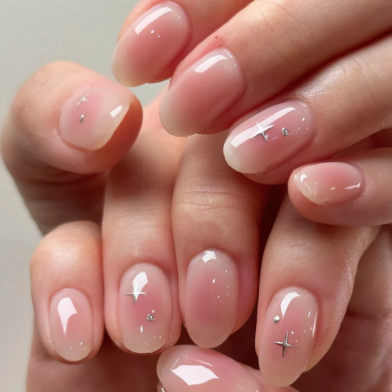 Elegant Glossy Nail Tips with Subtle Star Accents Stornfield
