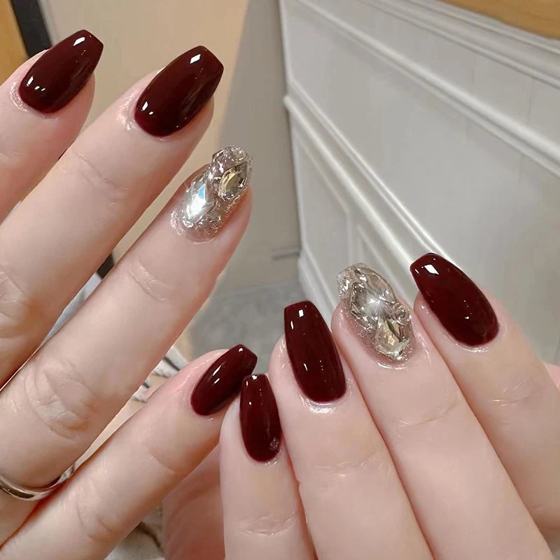 Artfully designed Gel nails with rhinestone decorations Stornfield
