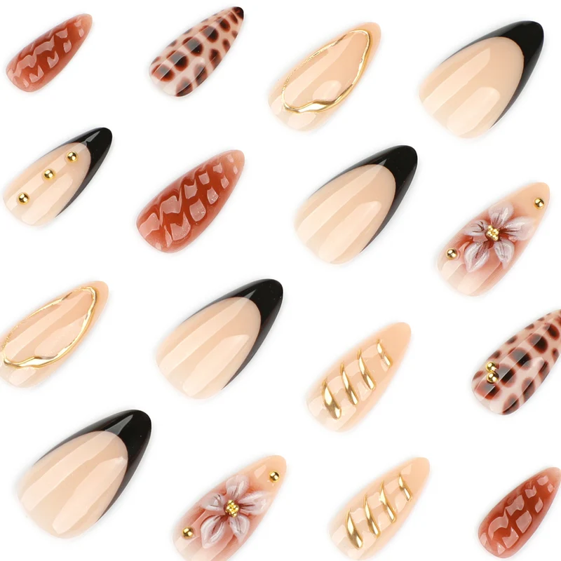 Artificial nails in modern stiletto design with golden accents Stornfield