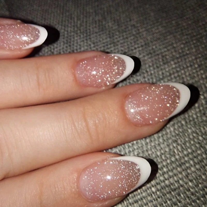 Artful nail art with glitter in gentle tones and elegant tips Stornfield