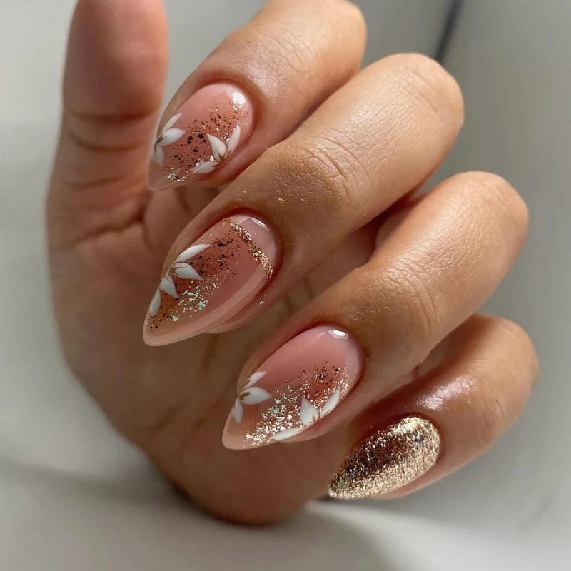 Artistic nail art with floral and glittering accents Stornfield