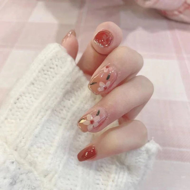 Artful nail art with floral motifs and glitter accents Stornfield