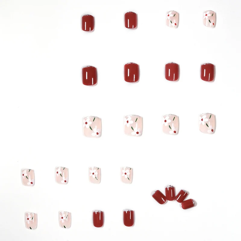 Artful nail art with floral motifs and glitter accents Stornfield