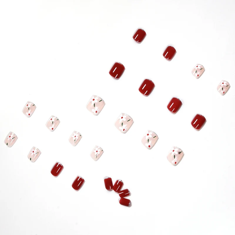 Artful nail art with floral motifs and glitter accents Stornfield