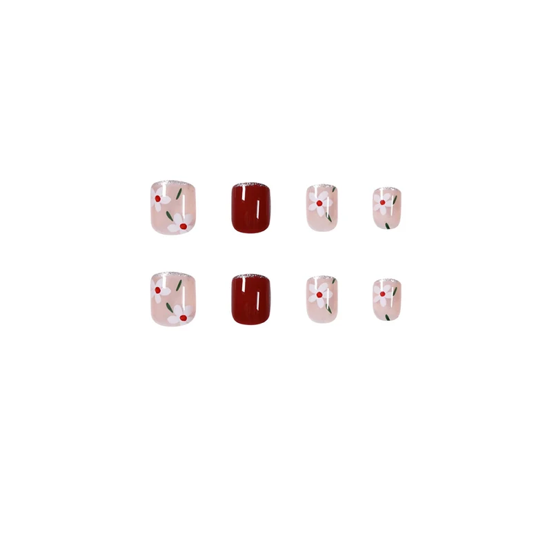Artful nail art with floral motifs and glitter accents Stornfield
