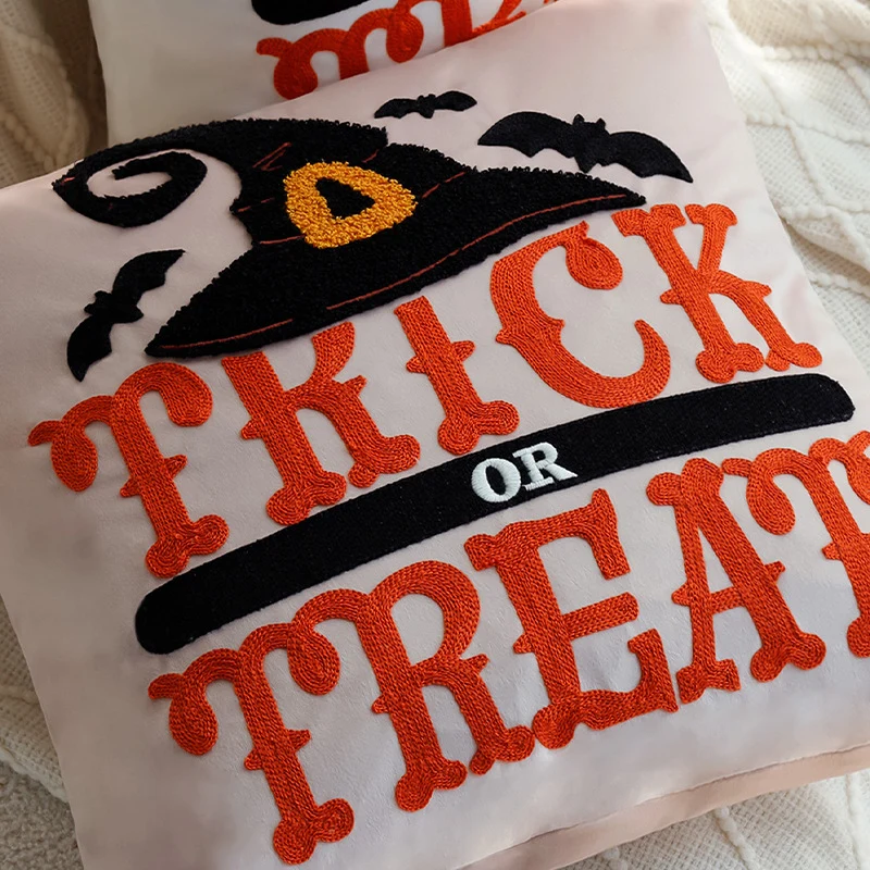 Square decorative cushion cover with witch hat appliqué and 'Trick or Treat' tufting Stornfield