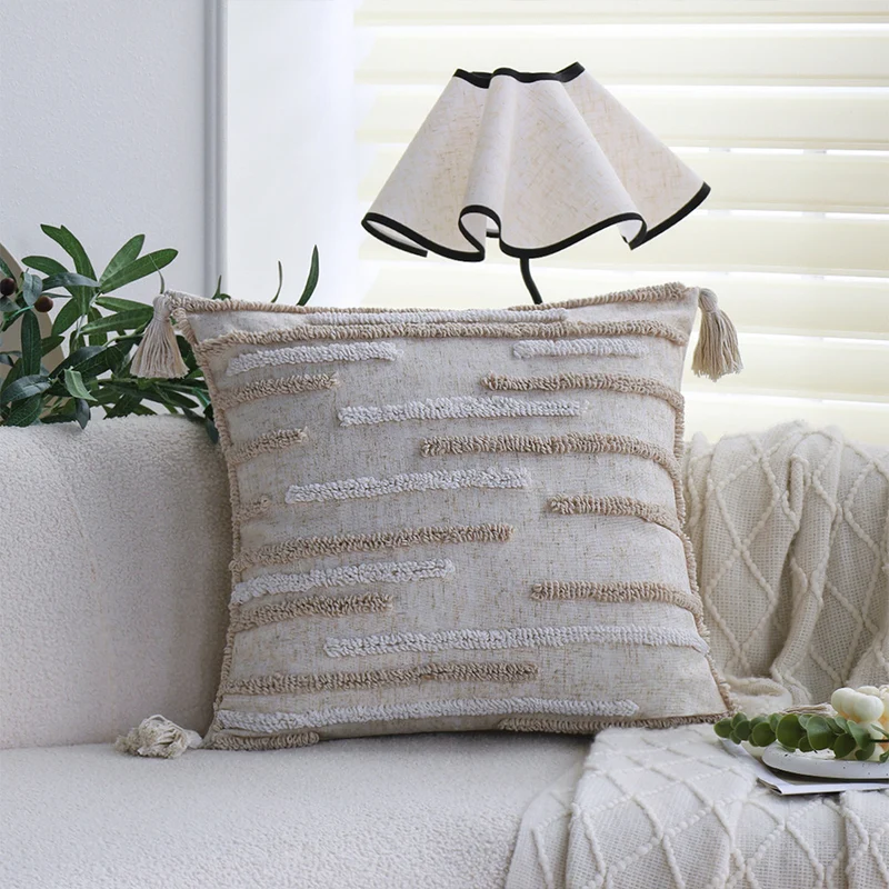 Square decorative cushion cover made of cotton-linen with hand-tufted stripe relief and corner tassels Stornfield