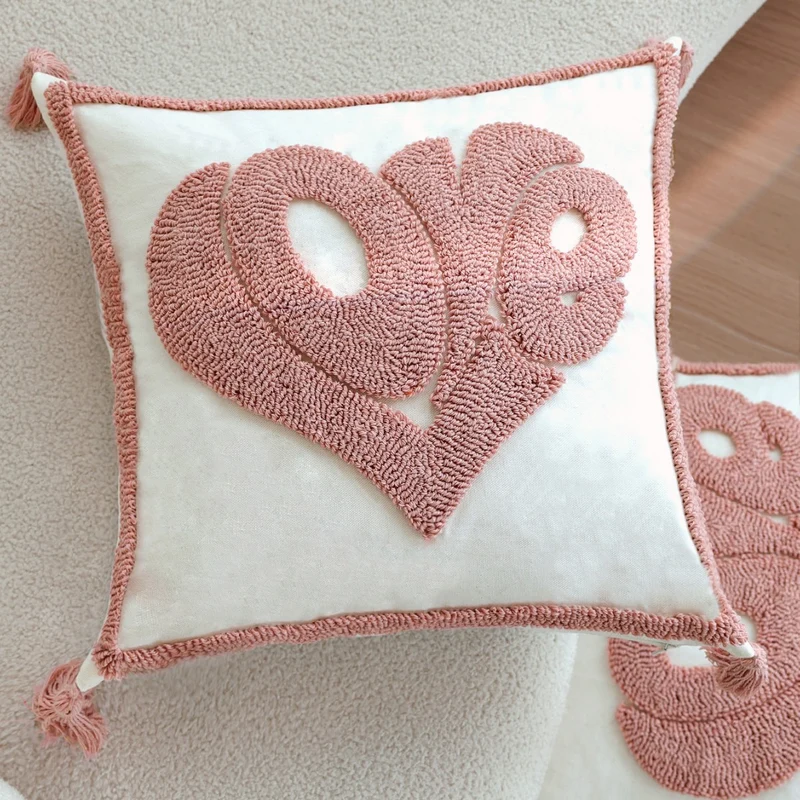 Square decorative cushion cover with hand-tufted heart appliqué, corner tassels, and velvet finish Stornfield