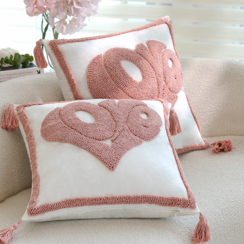 Square decorative cushion cover with hand-tufted heart appliqué, corner tassels, and velvet finish Stornfield