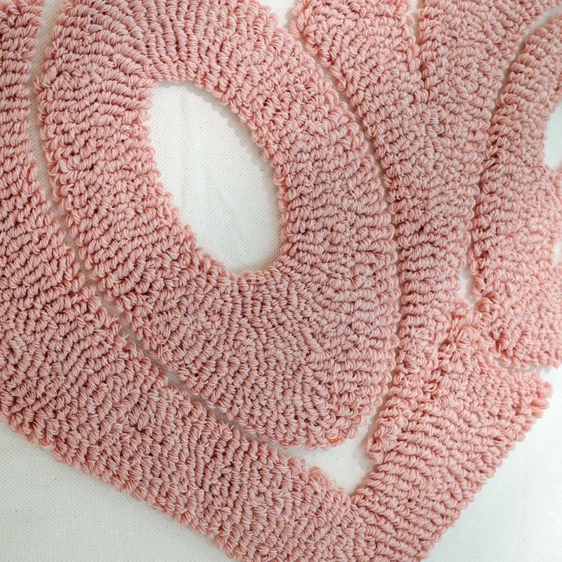 Square decorative cushion cover with hand-tufted heart appliqué, corner tassels, and velvet finish Stornfield