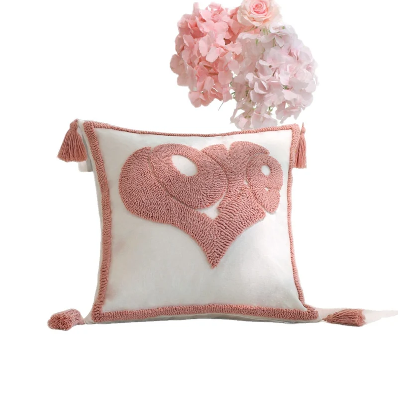 Square decorative cushion cover with hand-tufted heart appliqué, corner tassels, and velvet finish Stornfield