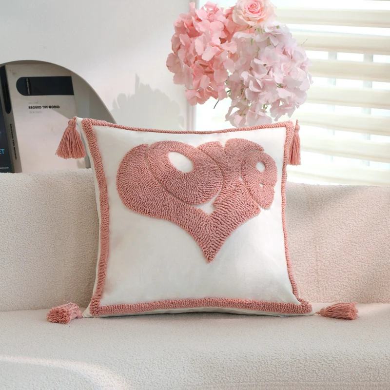 Square decorative cushion cover with hand-tufted heart appliqué, corner tassels, and velvet finish Stornfield