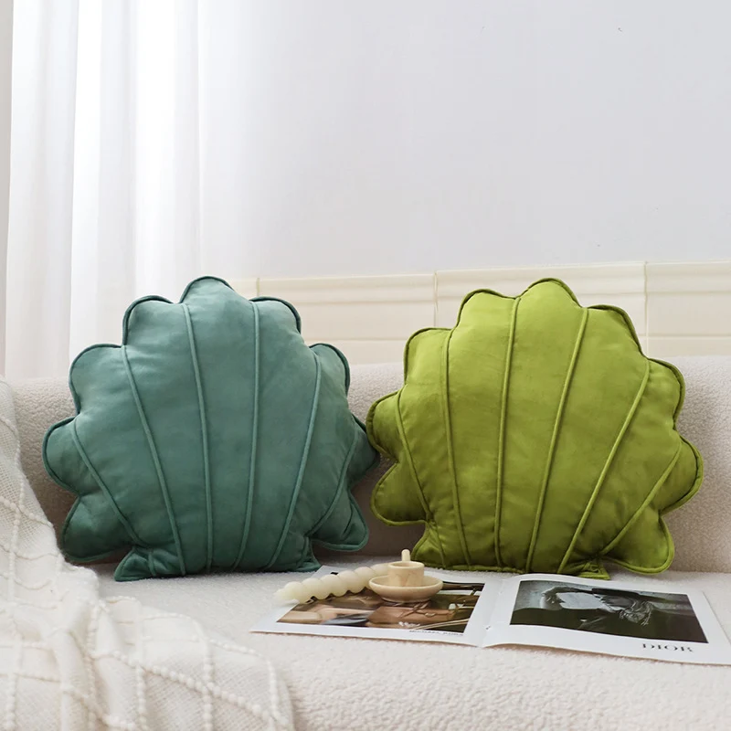 Shell-shaped decorative cushion made of soft velvet with vertical quilting Stornfield