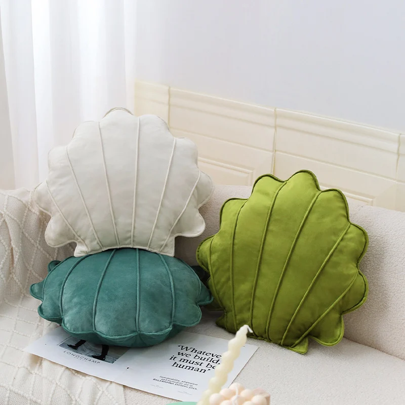 Shell-shaped decorative cushion made of soft velvet with vertical quilting Stornfield