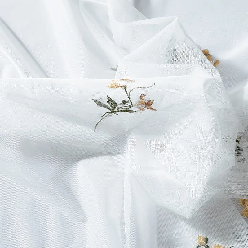 Embroidered sheer curtain panel made of fine tulle with floral embroidery relief and wavy hem Stornfield